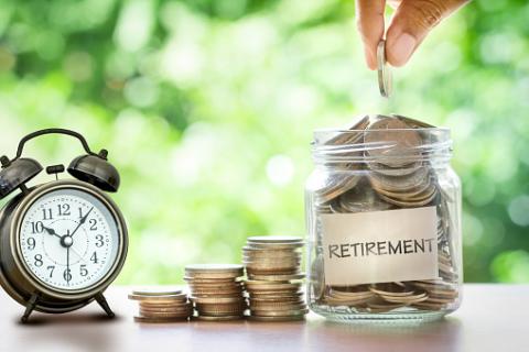 PHOTO: Thinkstock.com. Hand putting Coins in a glass jar with retro alarm clock